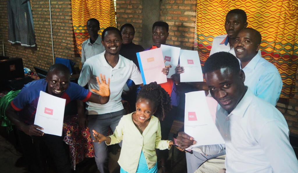Ryhmä afrikkalaisia nuoria miehiä todistuspaperit kädessään, edessä pienikokoinen nainen